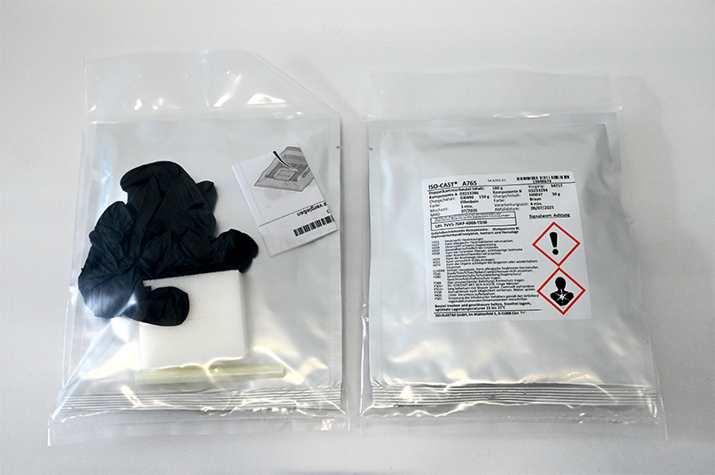 Silver aluminum bag with ISO-CAST® A765 label and black gloves