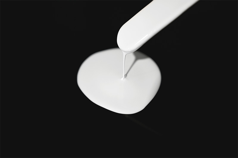 White, low-viscosity ISO-SIL 2500 potting material on a black background.